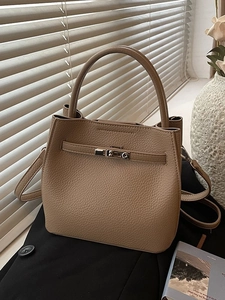 Minimalist khaki lychee grain leather bucket bag with top handle and metal turn-lock