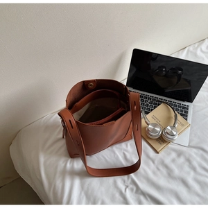 Macro shot of caramel brown tote bag interior with inner pouch and magnetic closure