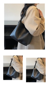 Detail of black lychee grain leather bucket bag with adjustable shoulder strap for women