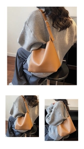 Detail of brown litchi pattern leather shoulder bag with adjustable strap and hobo design