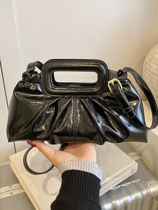 Elegant black glossy pleated tote bag with rectangular handle and adjustable shoulder strap