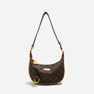 Detail of vintage monogram hobo bag with leather trim and adjustable shoulder strap