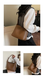 Close-up of soft brown lychee grain leather texture on minimalist women's tote bag