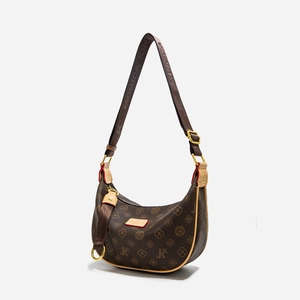 Detail of vintage hobo bag with monogram pattern and adjustable nylon wide strap