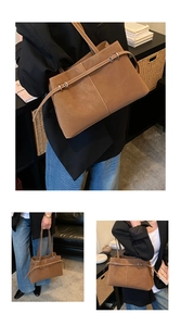 Close-up of matte brown leather tote bag detailing buckle straps and white stitching