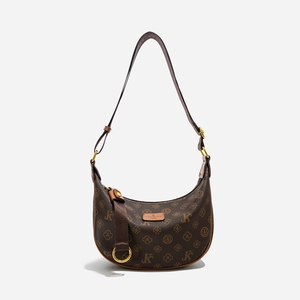 Detail of monogram canvas crescent bag featuring leather brand tag and golden zipper