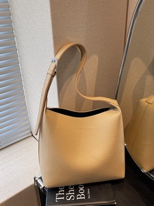 Minimalist khaki leather tote bag with lychee texture and silver buckle for women