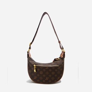 Detail of half-moon shoulder bag with retro monogram pattern and gold metal hardware