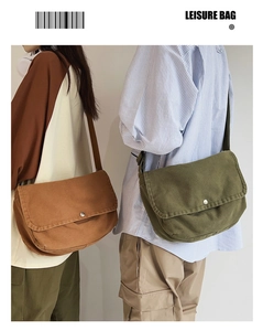 Close-up of canvas crossbody bags in brown and green with adjustable straps