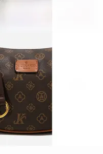 Detailed close-up of brown monogram canvas texture and gold-tone metal hardware