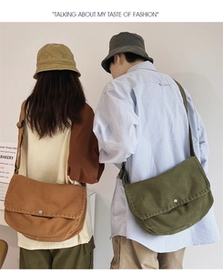 Detail of canvas messenger bags in caramel brown and olive green with adjustable straps