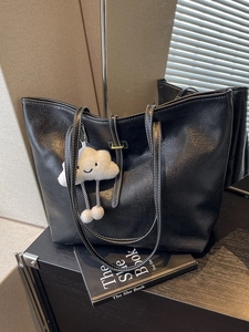 Retro black leather tote bag with white contrast stitching and plush cloud charm decor