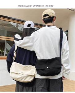 Detail of canvas crossbody bags in black and beige with metallic magnetic snap closures