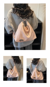 Detail of pink faux leather bag featuring silver chain and heart-shaped metal pendant