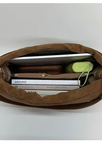 Spacious brown tote bag interior showing large capacity for books and tablet
