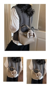 Detailed close-up of khaki pebbled leather bucket bag featuring a plush rabbit pendant