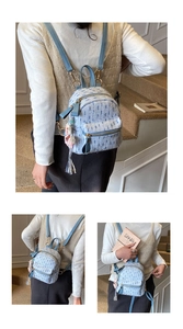 Detail of light blue tweed mini backpack with gold hardware and tassel charm accent