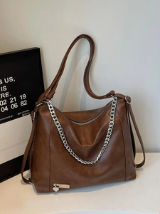 Brown vintage faux leather tote bag with silver chain and heart charm detail