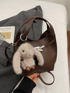 Brown litchi pattern bucket handbag with silver lock and plush rabbit charm
