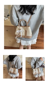 Close-up of contrast color garden bag with lace bow and pearl charm details