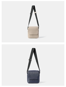 Detailed view of gray and navy crossbody bags with adjustable straps and embossed logo
