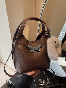 Brown litchi grain leather bucket bag with silver buckle and plush bunny charm