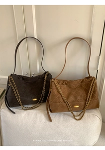 Detail showing suede quilted tote bags with elegant gold chain accents and retro texture