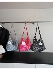 Detailed display of crossbody bags with abstract floral patterns and plush charms