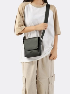 Crossbody bag for women in black PU leather with wide adjustable strap worn by model