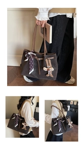 Detail view of coffee brown tote bag with floral scarf and cute plush rabbit charm