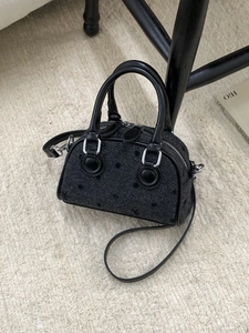 Chic black polka dot mini Boston bag with leather trim and detachable shoulder strap