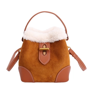 Détails du sac seau en daim marron avec bordure en peluche blanche et fermoir doré