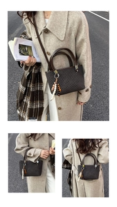 Detail of dark brown checkered bucket bag featuring wooden bead charm and silver hardware