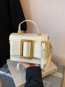Chic cream white leather square handbag with large gold buckle and shoulder strap