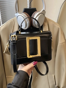 Classic black high-gloss rectangle handbag with a bold gold buckle and leather strap