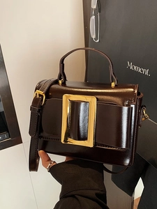 Deep brown glossy leather crossbody bag with iconic gold square buckle and top handle