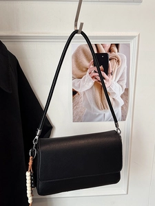 Minimalistische schwarze Leder-Umhängetasche mit Silberbeschlägen und Perlenanhänger
