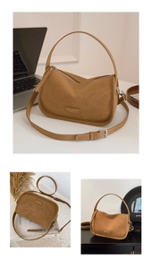 Close-up of brown suede crossbody bag with metal zipper and adjustable strap details