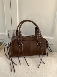 Retro dark brown leather underarm bag with unique cross-lace design and long tassels