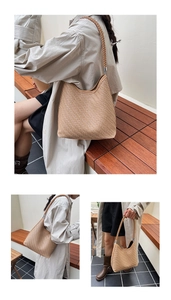 Detail of beige woven bucket bag featuring herringbone pattern and braided shoulder strap