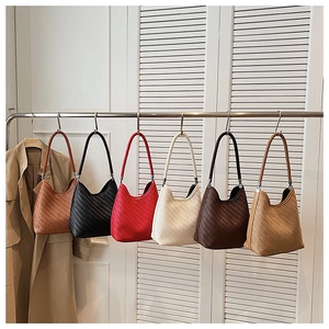 Selection of woven bucket bags in caramel, black, red, cream, dark coffee and khaki colors