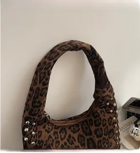 Leopard print tote bag detail showing silver rivet studs and metal zipper closure