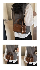 Detailed views of a brown vintage leather handbag with bead charms and strap detail
