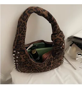Detailed interior of leopard print tote bag showing spacious storage and silver studs