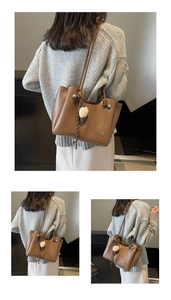 Brown faux leather tote bag detail with ice cream charm and stylish shoulder strap