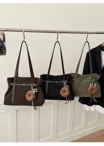 Detailed close-up of large tote bags in matte finish with decorative plush donut charms