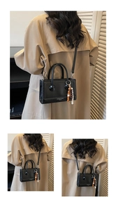Detailed views of a black mini square handbag with wooden bead charm and thin strap