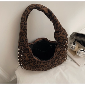 Close-up of leopard print hobo bag with silver rivets and knotted strap detail