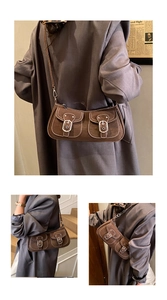 Detail of vintage brown underarm bag with double pockets and white contrast stitching