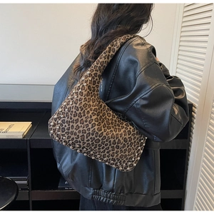 Macro detail of leopard print tote bag with silver studs and stylish punk metal hardware